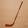 A hockey player holding a hockey stick in a sports setting.