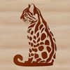 A medium-sized wild cat with a slender body and long tail sits on its haunches.