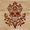An ornate skull design suitable for tattoo art or Halloween decorations.