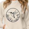 Detailed Floral and Feathered Artwork A vector graphic design featuring a detailed hummingbird surrounded by foliage.