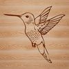 A colorful hummingbird in mid-air, its wings spread wide as it flutters between flowers.
