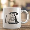 An illustration of a classic telephone with a rotary dial and receiver.
