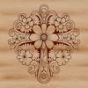 A decorative silver-colored crucifix with intricate floral details on the crossbar.