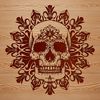 A detailed ornate skull illustration with intricate design elements suitable for tattoo designs or custom crafts.