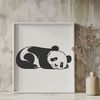 Resting Black and White Bear A cute black-and-white panda bear resting on its side, suitable for use as clip art in various design projects.