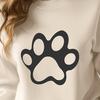 A single animal paw print made up of fine lines and subtle curves, designed as a reusable vector graphic.
