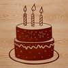 A colorful birthday cake with candles lit on top, made up of layered fondant and buttercream frosting.