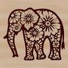 A standing African elephant with intricate floral patterns on its body.