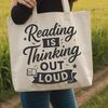 A stylized illustration of a person reading a book with inspirational quotes in the background.