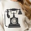 Vintage Telephone Icon A simple illustration of a classic telephone with a receiver and keypad.