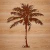 Beachside Palm Tree Silhouette Vector Art A single palm tree standing in a beach-like environment with clear blue skies.
