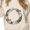 An editable clip art illustration of a wreath composed of interlocking flowers and foliage.