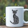 Edible Vector Big Cat Illustration A small wild big cat sitting in a natural setting, illustration created as an editable vector graphic.